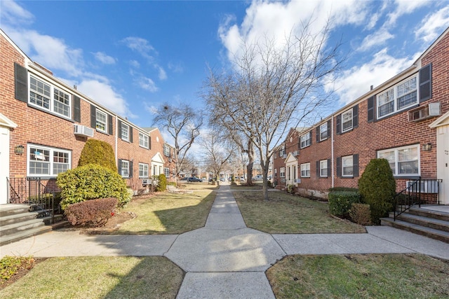 surrounding community with a residential view and a lawn