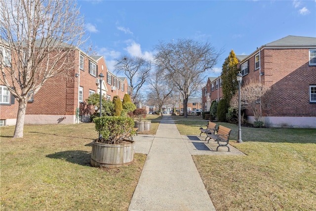 view of property's community with a residential view and a yard