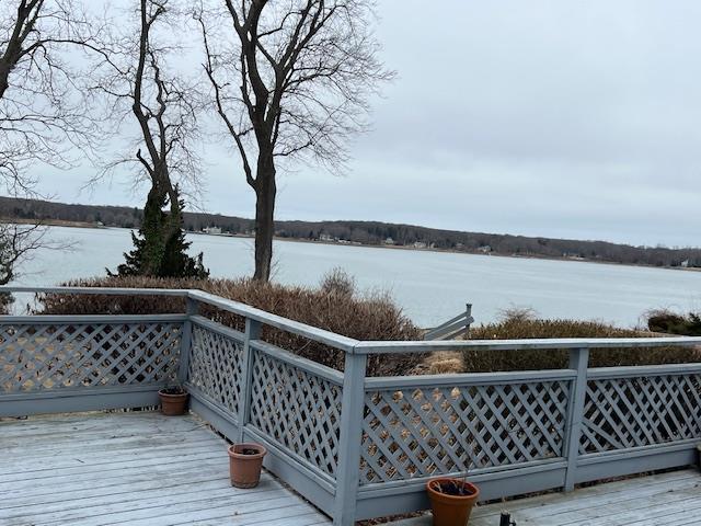 wooden deck featuring a water view