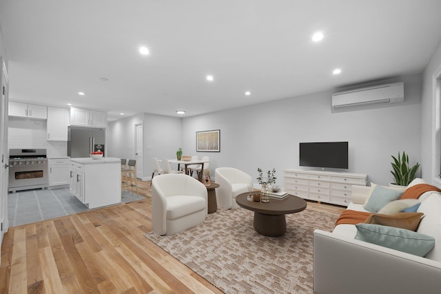 living room with a wall mounted air conditioner and light wood-type flooring