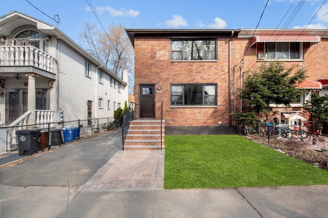 15815 77th Rd, Fresh Meadows, NY 11366 - view of front of house featuring brick siding, a front yard, fence, and a balcony