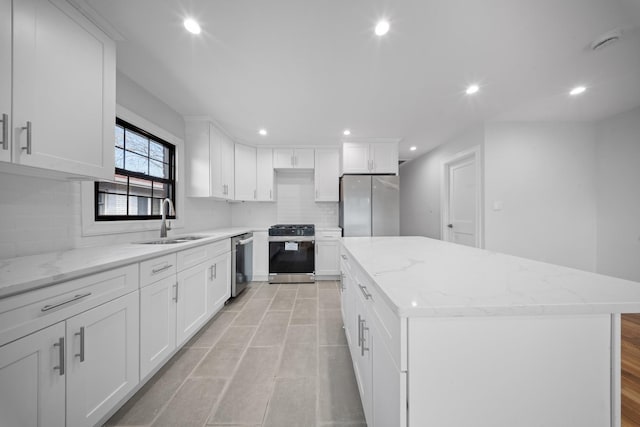 15815 77th Rd, Fresh Meadows, NY 11366 - kitchen featuring white cabinets, a sink, a kitchen island, and appliances with stainless steel finishes