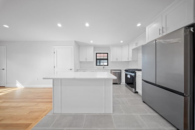 15815 77th Rd, Fresh Meadows, NY 11366 - kitchen featuring light countertops, recessed lighting, stainless steel appliances, a kitchen island, and white cabinets