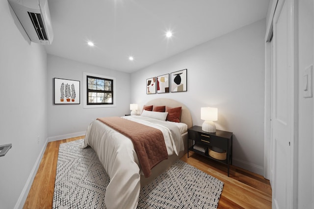 15815 77th Rd, Fresh Meadows, NY 11366 - bedroom featuring baseboards, light wood-type flooring, a wall unit AC, and recessed lighting