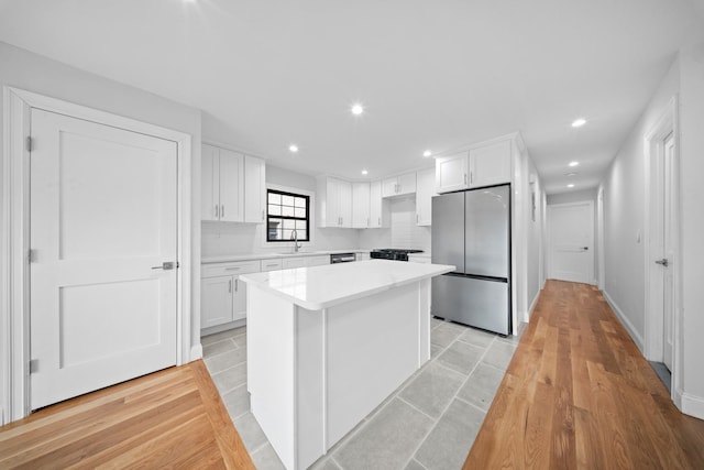 15815 77th Rd, Fresh Meadows, NY 11366 - kitchen with white cabinets, light countertops, a center island, and freestanding refrigerator