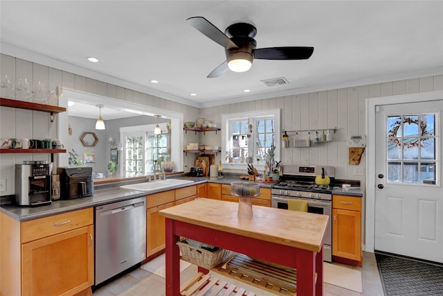 kitchen featuring hanging light fixtures, appliances with stainless steel finishes, sink, and plenty of natural light