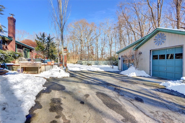 yard layered in snow with a garage