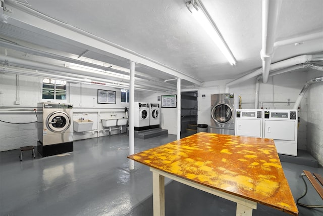 community laundry room with separate washer and dryer and a sink