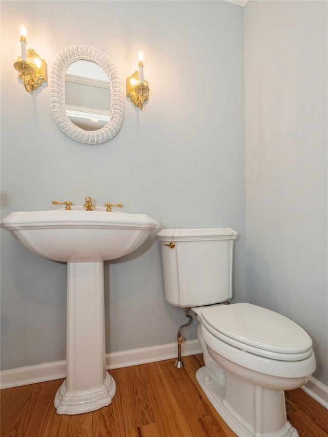 bathroom featuring hardwood / wood-style floors, sink, and toilet