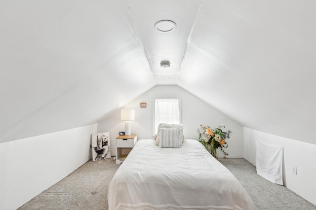 bedroom with vaulted ceiling and carpet flooring