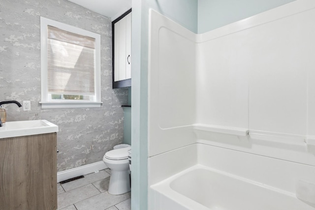 full bathroom with toilet, wallpapered walls, tile patterned flooring, baseboards, and vanity