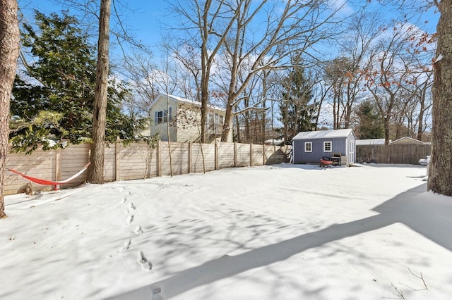 yard covered in snow with a shed