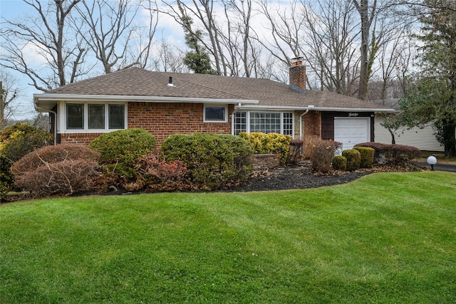 single story home featuring a garage, brick siding, a chimney, roof with shingles, and a front yard