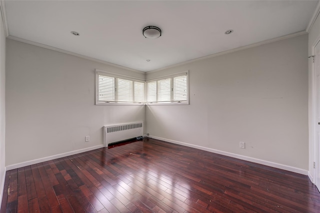 spare room with ornamental molding, radiator, wood-type flooring, and baseboards