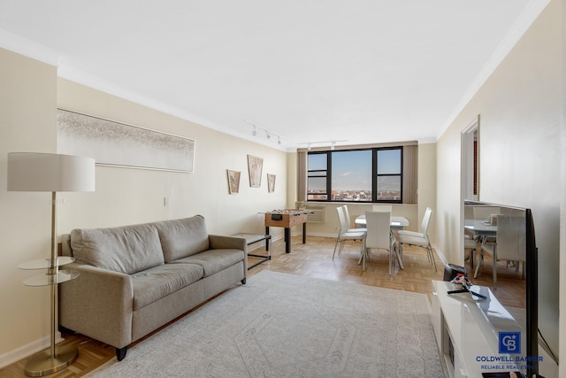 living room with light parquet flooring, track lighting, and crown molding