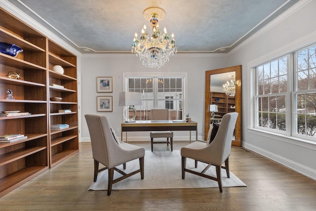 office area featuring hardwood / wood-style flooring, ornamental molding, a healthy amount of sunlight, and an inviting chandelier