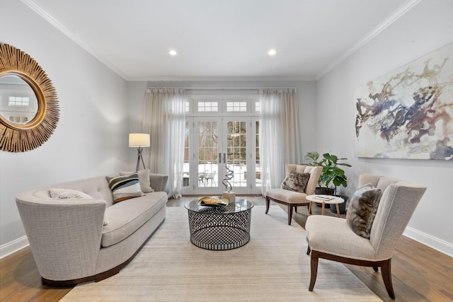 living room featuring hardwood / wood-style floors, crown molding, and french doors