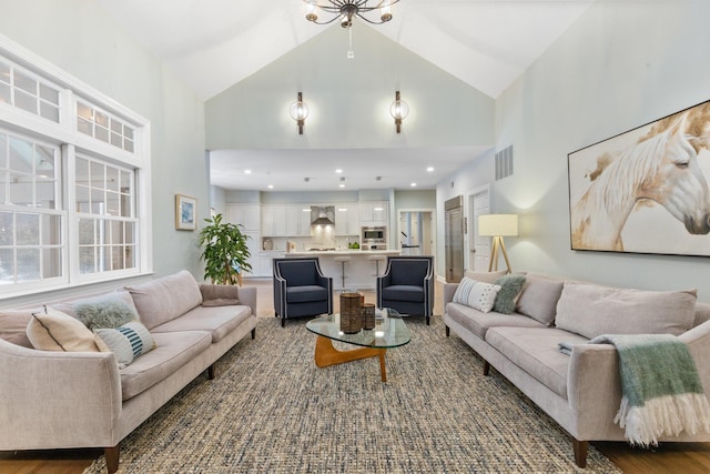 living room featuring dark wood-type flooring and high vaulted ceiling