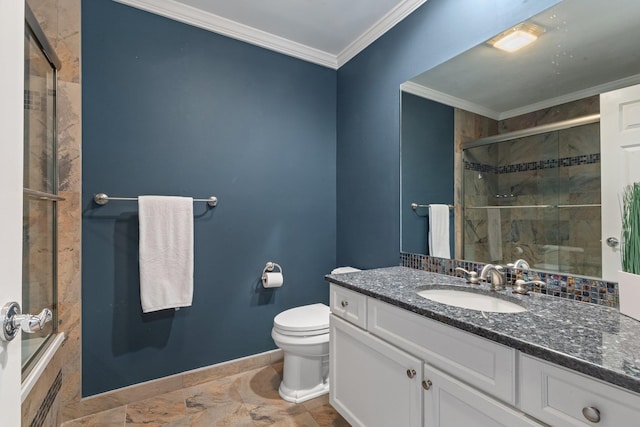 bathroom with ornamental molding, toilet, vanity, and a shower with shower door