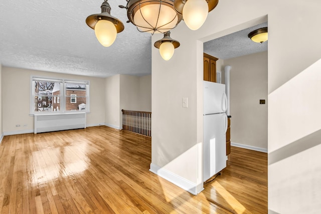 interior space featuring light hardwood / wood-style flooring and a textured ceiling