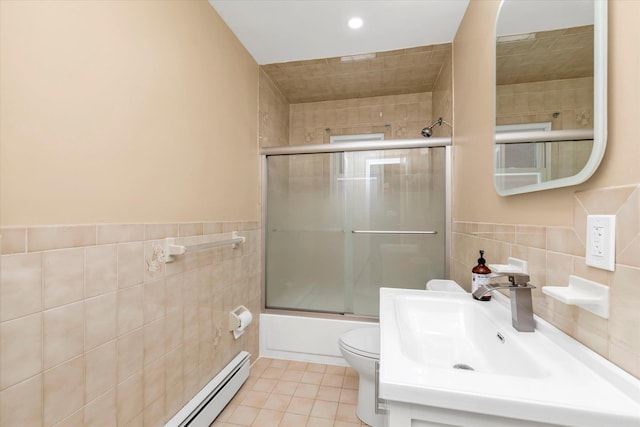 full bathroom featuring sink, tile walls, enclosed tub / shower combo, toilet, and tile patterned floors