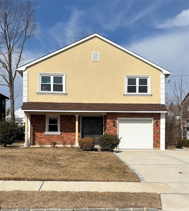 traditional-style house featuring concrete driveway, brick siding, an attached garage, and stucco siding