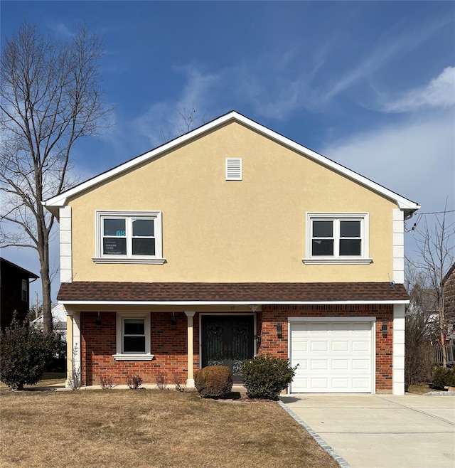 traditional-style house featuring a garage, brick siding, driveway, and stucco siding