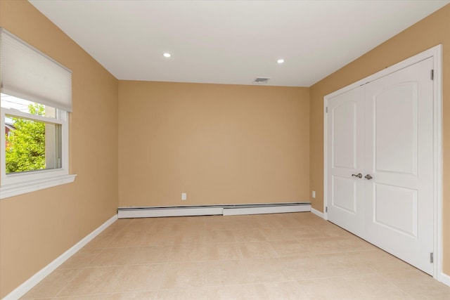 unfurnished room with visible vents, light tile patterned flooring, baseboards, recessed lighting, and a baseboard heating unit