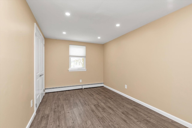 unfurnished room featuring baseboards, a baseboard radiator, recessed lighting, and wood finished floors