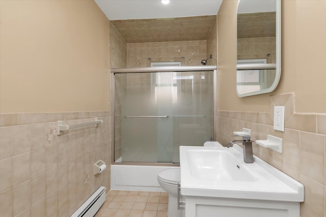 full bathroom featuring vanity, toilet, tile patterned floors, tile walls, and combined bath / shower with glass door