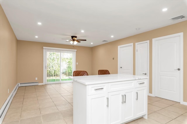 kitchen with light tile patterned floors, a baseboard radiator, a ceiling fan, and visible vents