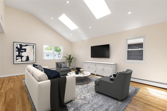 69 Woodward St, Roslyn Heights, NY 11577 - living area featuring wood finished floors, high vaulted ceiling, a skylight, a baseboard radiator, and recessed lighting