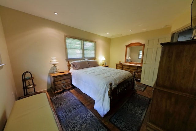 bedroom with dark wood-style floors and recessed lighting