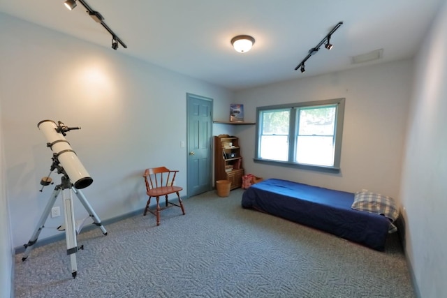 bedroom featuring track lighting, visible vents, and carpet flooring