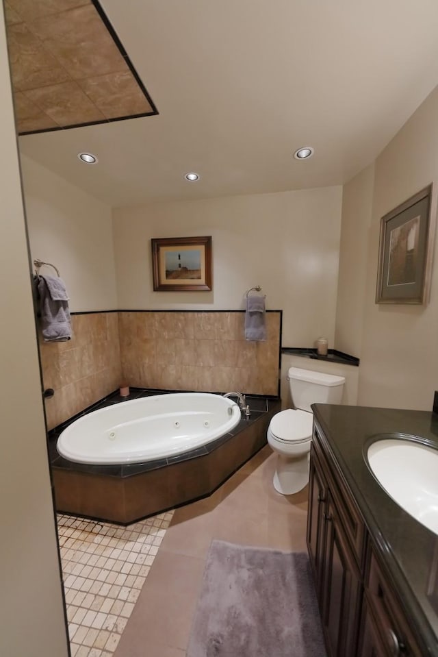 full bath featuring toilet, a whirlpool tub, tile patterned flooring, vanity, and recessed lighting