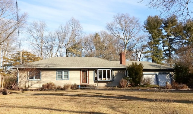 ranch-style house featuring entry steps, a chimney, and a front yard