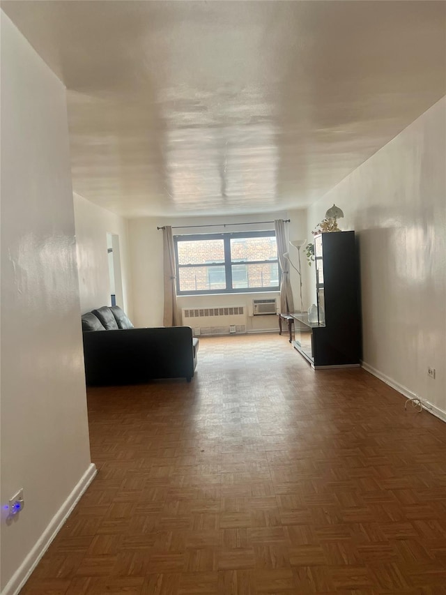 unfurnished living room featuring a wall mounted air conditioner, radiator heating unit, and dark parquet floors