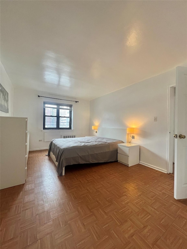 bedroom featuring light parquet flooring