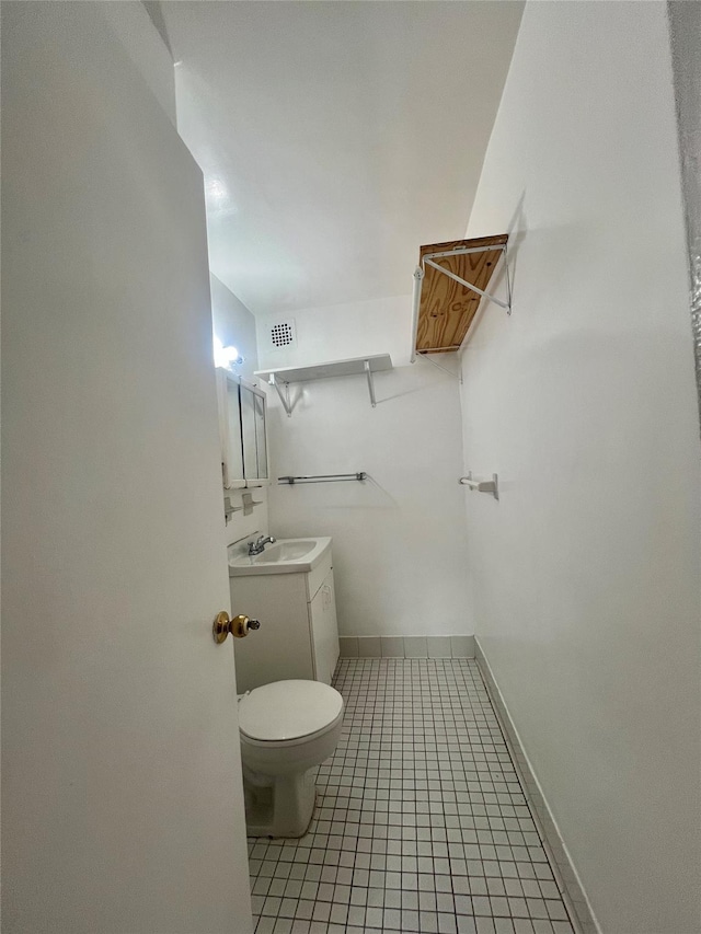 bathroom featuring vanity, toilet, and tile patterned flooring