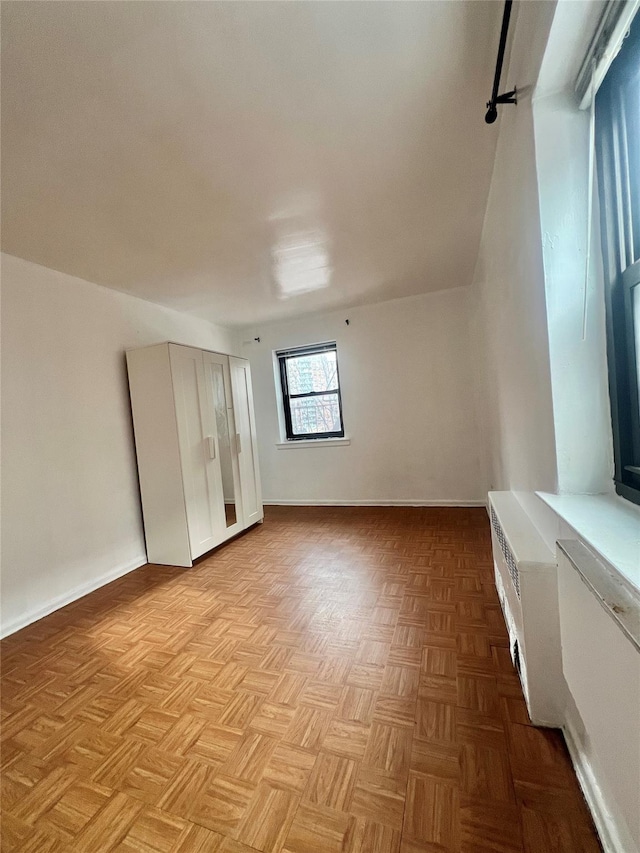 additional living space featuring light parquet flooring