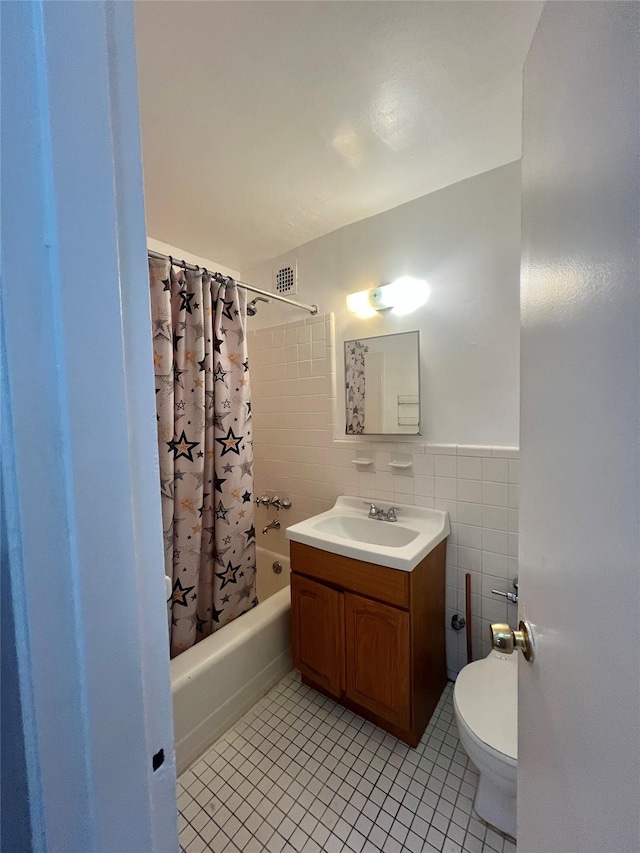 full bathroom with tile walls, shower / tub combo, tile patterned floors, and toilet