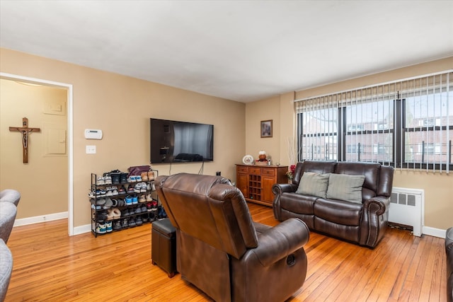 living room featuring radiator and light hardwood / wood-style floors