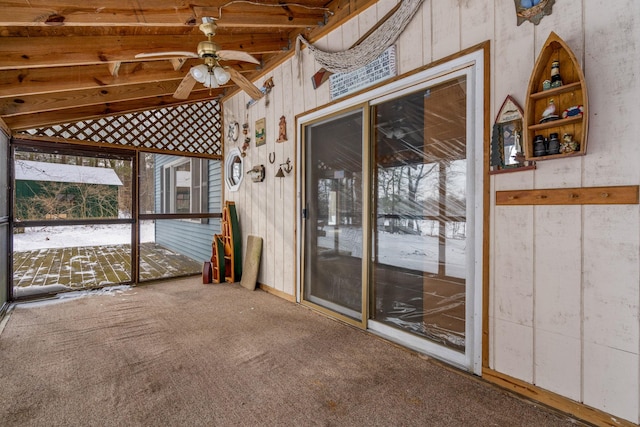 unfurnished sunroom with vaulted ceiling with beams and ceiling fan