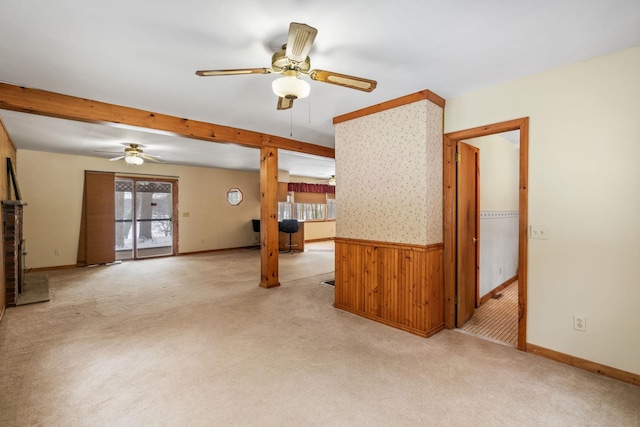 unfurnished living room with ceiling fan, light carpet, and a wealth of natural light