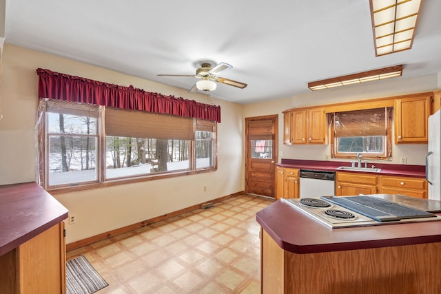 kitchen with stainless steel appliances, sink, ceiling fan, and kitchen peninsula