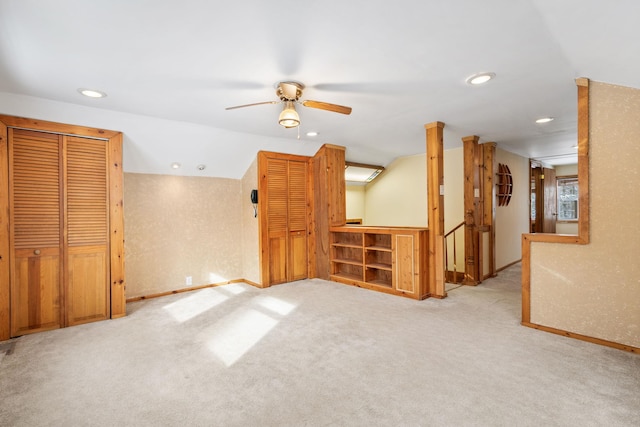 carpeted empty room with ceiling fan and vaulted ceiling