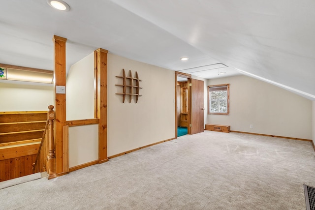 bonus room featuring vaulted ceiling and carpet