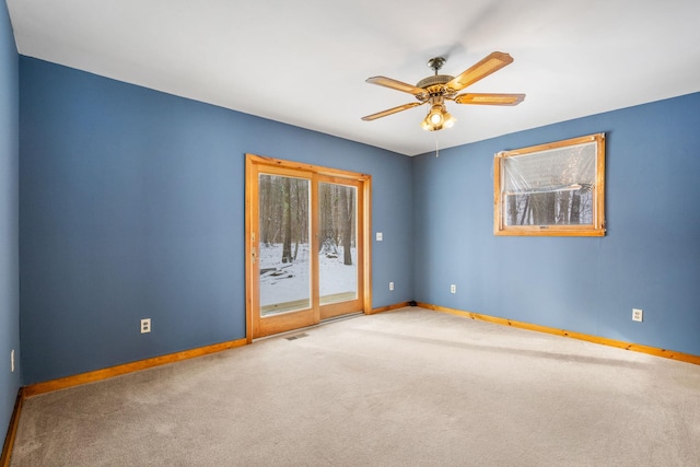 spare room featuring ceiling fan and carpet floors