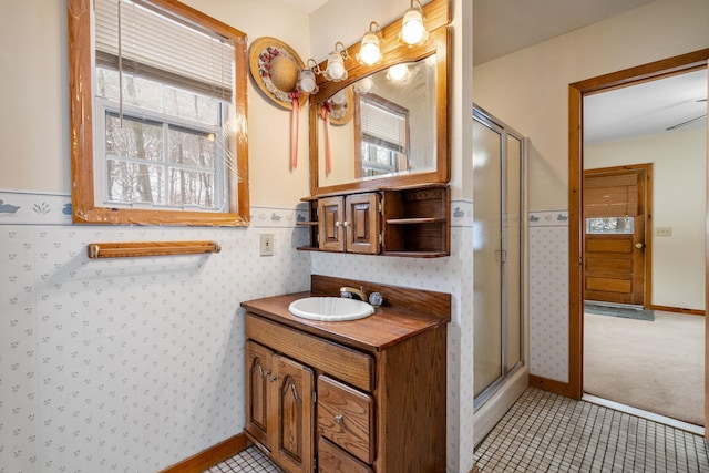 bathroom featuring tile patterned floors, vanity, and a shower with door