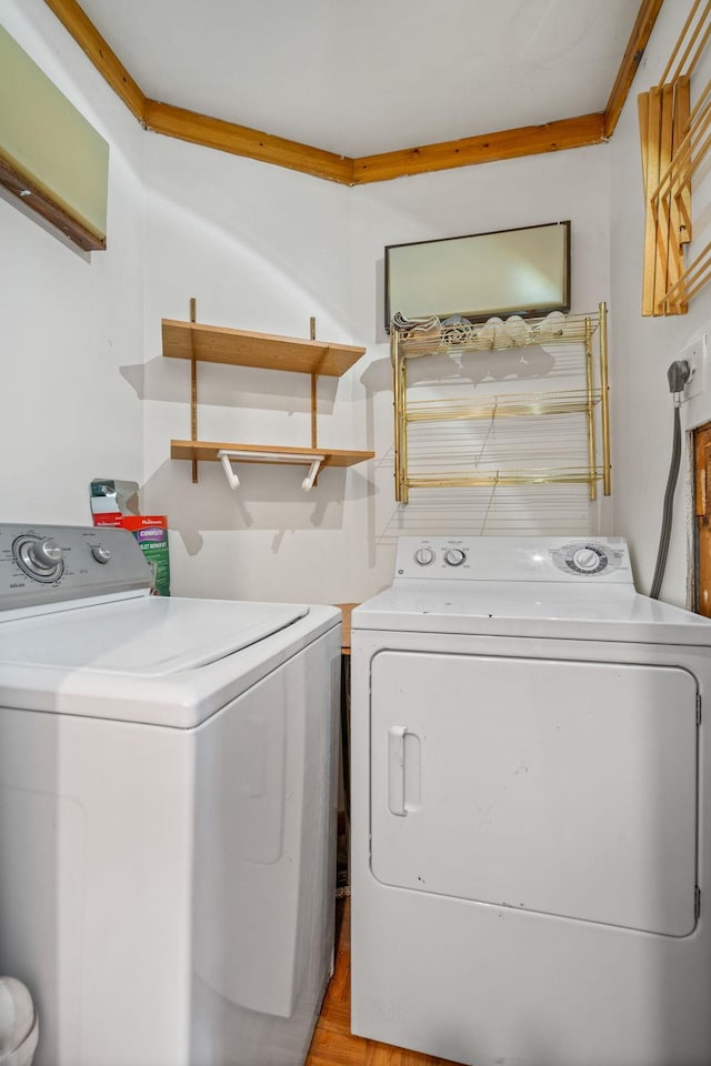 clothes washing area with washing machine and clothes dryer